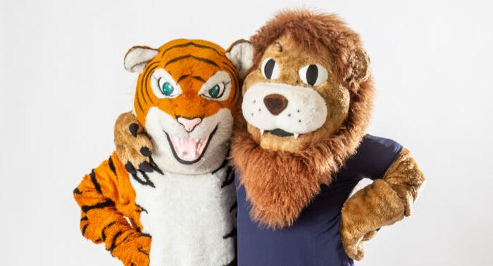 A&M-Commerce lion mascot with a tiger mascot.